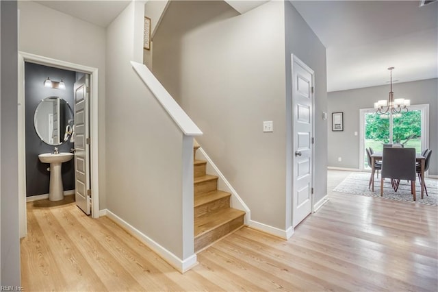 123 Getty Rd, Suffolk, VA 23434 - stairway with a chandelier, wood finished floors, and baseboards
