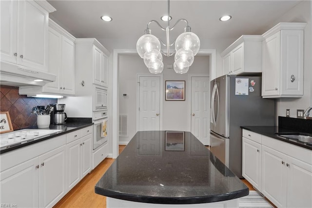 20185 Harbour Rdg, Smithfield, VA 23430 - kitchen featuring white appliances, under cabinet range hood, a sink, white cabinetry, and decorative backsplash