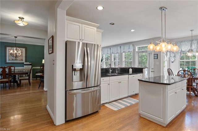 20185 Harbour Rdg, Smithfield, VA 23430 - kitchen featuring stainless steel refrigerator with ice dispenser, a chandelier, white dishwasher, dark countertops, and a sink
