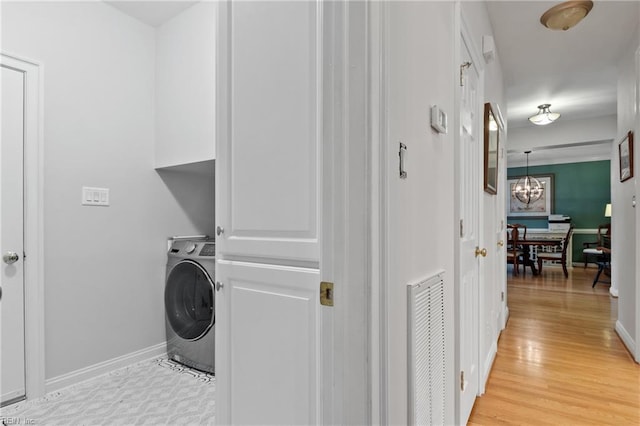 20185 Harbour Rdg, Smithfield, VA 23430 - washroom with washer / clothes dryer, cabinet space, a chandelier, light wood finished floors, and baseboards