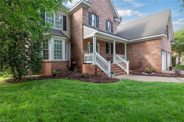 20185 Harbour Rdg, Smithfield, VA 23430 - traditional home with covered porch, brick siding, a front yard, a shingled roof, and a garage