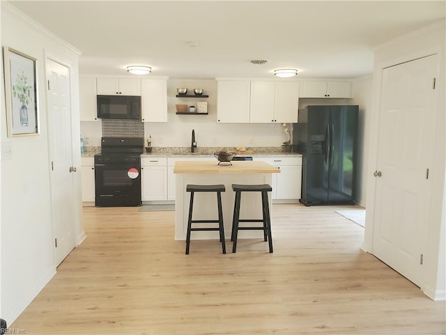 1215 Hale Dr, Hampton, VA 23663 - kitchen featuring black appliances, white cabinetry, ornamental molding, light wood finished floors, and a sink