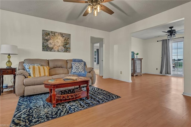 506 Everett Dr, Elizabeth City, NC 27909 - living room featuring a ceiling fan, wood finished floors, baseboards, and a textured ceiling