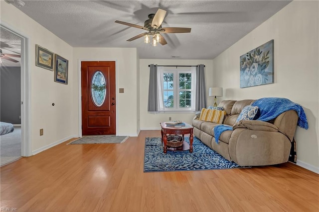 506 Everett Dr, Elizabeth City, NC 27909 - living area featuring ceiling fan, wood finished floors, a textured ceiling, and baseboards