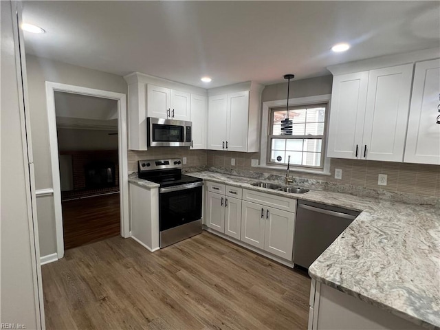 6217 Apple St, Suffolk, VA 23435 - kitchen featuring appliances with stainless steel finishes, a sink, wood finished floors, white cabinets, and recessed lighting
