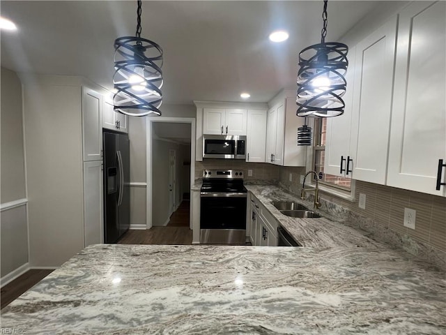 6217 Apple St, Suffolk, VA 23435 - kitchen featuring appliances with stainless steel finishes, a sink, light stone counters, white cabinetry, and recessed lighting