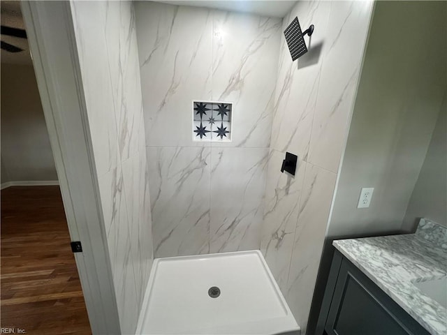 6217 Apple St, Suffolk, VA 23435 - bathroom featuring a marble finish shower, vanity, wood finished floors, and baseboards