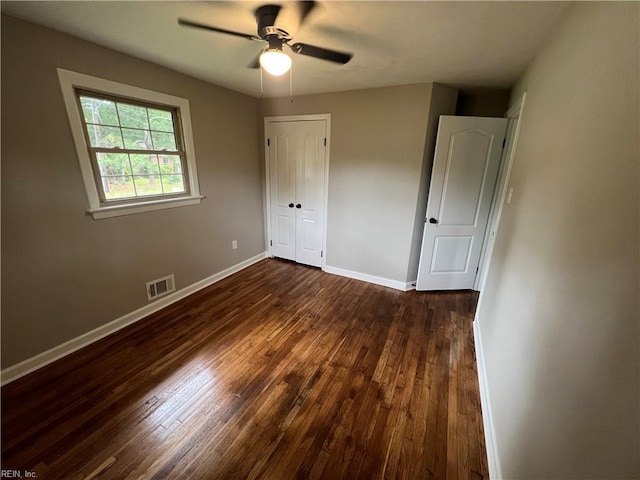 6217 Apple St, Suffolk, VA 23435 - unfurnished bedroom with dark wood finished floors, baseboards, a closet, and a ceiling fan