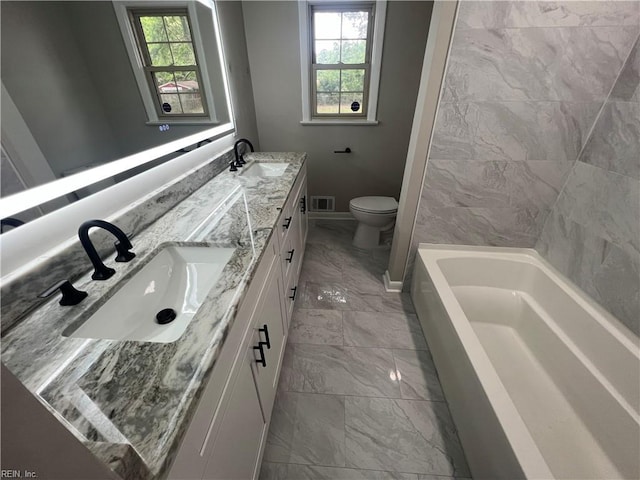 6217 Apple St, Suffolk, VA 23435 - full bath with marble look tile flooring, double vanity, toilet, and baseboards
