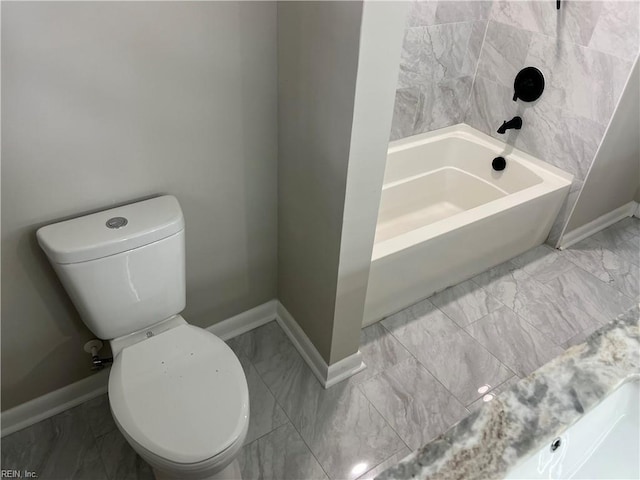 6217 Apple St, Suffolk, VA 23435 - bathroom featuring toilet, a tub, baseboards, and marble look tile flooring