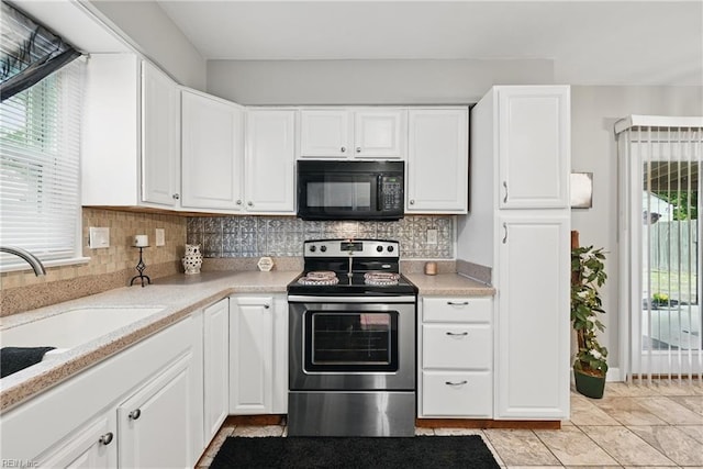 2405 Minnesota Ave, Norfolk, VA 23513 - kitchen with black microwave, electric stove, a sink, white cabinets, and backsplash