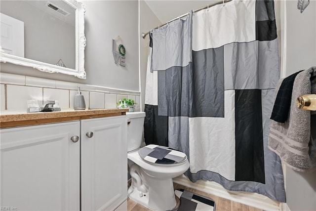 2405 Minnesota Ave, Norfolk, VA 23513 - bathroom with toilet, vanity, wood finished floors, wainscoting, and a shower with shower curtain