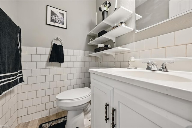 2405 Minnesota Ave, Norfolk, VA 23513 - bathroom with tile walls, toilet, vanity, wood finished floors, and a wainscoted wall