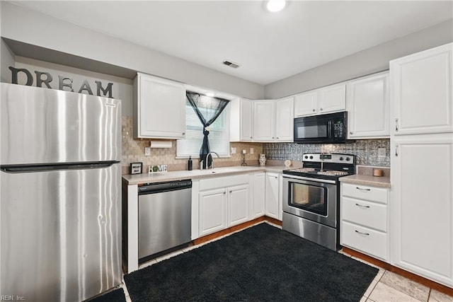 2405 Minnesota Ave, Norfolk, VA 23513 - kitchen featuring appliances with stainless steel finishes, decorative backsplash, and light countertops