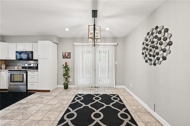 2405 Minnesota Ave, Norfolk, VA 23513 - kitchen with electric range, black microwave, backsplash, white cabinets, and recessed lighting