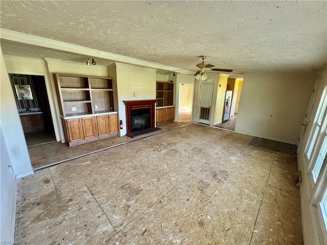 15310 Loco School Rd, Stony Creek, VA 23882 - unfurnished living room with a textured ceiling, ceiling fan, ornamental molding, a fireplace with raised hearth, and baseboards