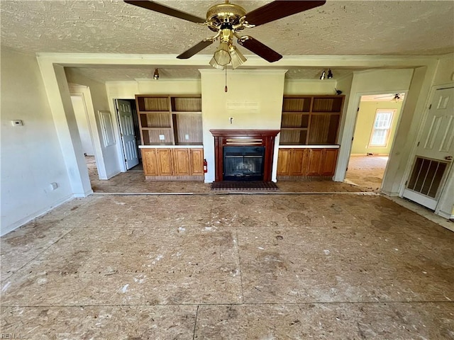 15310 Loco School Rd, Stony Creek, VA 23882 - unfurnished living room with a textured ceiling, baseboards, ceiling fan, and a glass covered fireplace