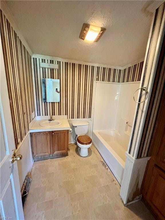 15310 Loco School Rd, Stony Creek, VA 23882 - full bathroom with wallpapered walls, toilet, vanity, and stone finish floors