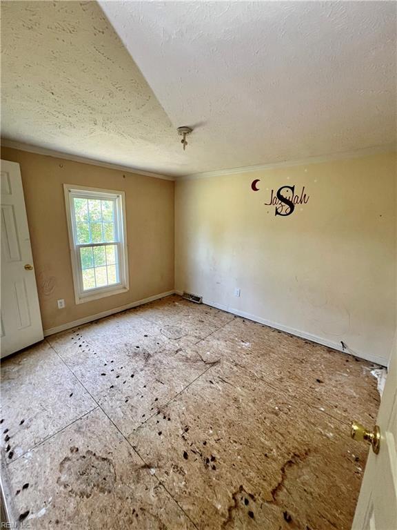 15310 Loco School Rd, Stony Creek, VA 23882 - empty room featuring a textured ceiling and ornamental molding