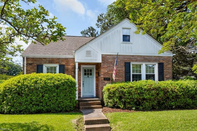 1011 Norview Ave, Norfolk, VA 23513 - view of front facade with a front yard, brick siding, board and batten siding, and a shingled roof
