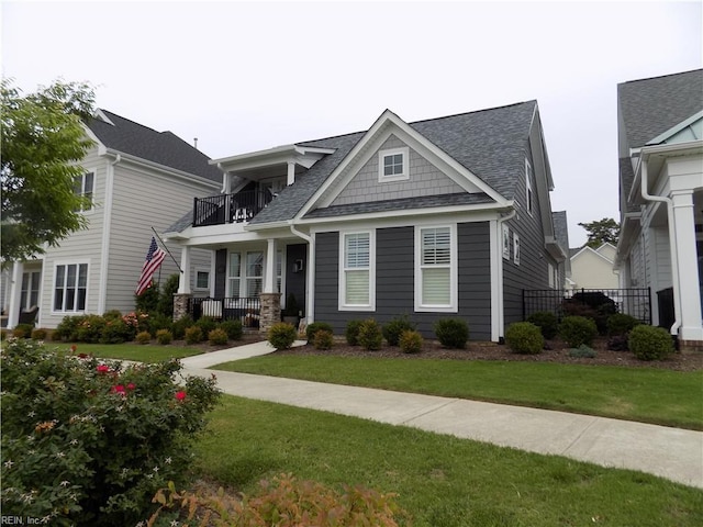 115 Creek Ln, Suffolk, VA 23435 - craftsman-style house featuring a balcony, a shingled roof, a front lawn, and a porch