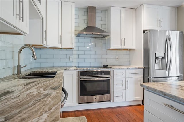725 Lord Nelson Dr, Virginia Beach, VA 23464 - kitchen with stainless steel appliances, wall chimney exhaust hood, a sink, and white cabinets