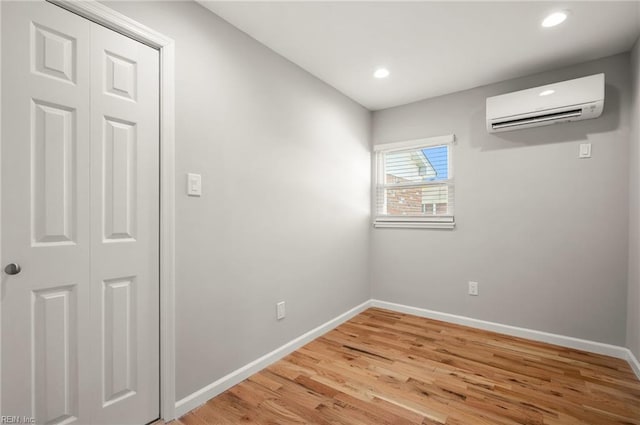725 Lord Nelson Dr, Virginia Beach, VA 23464 - empty room with a wall unit AC, baseboards, light wood-style floors, and recessed lighting