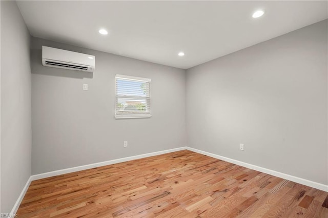 725 Lord Nelson Dr, Virginia Beach, VA 23464 - unfurnished room featuring a wall unit AC, light wood finished floors, baseboards, and recessed lighting