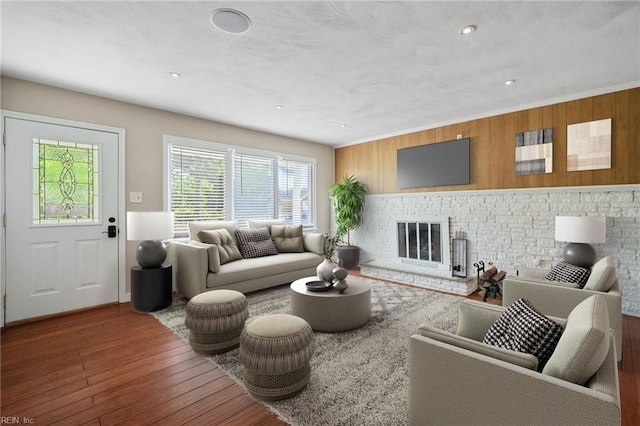 725 Lord Nelson Dr, Virginia Beach, VA 23464 - living room with wood finished floors, wooden walls, a fireplace, and recessed lighting