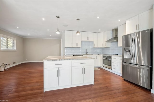 725 Lord Nelson Dr, Virginia Beach, VA 23464 - kitchen with appliances with stainless steel finishes, wall chimney range hood, a sink, crown molding, and baseboards