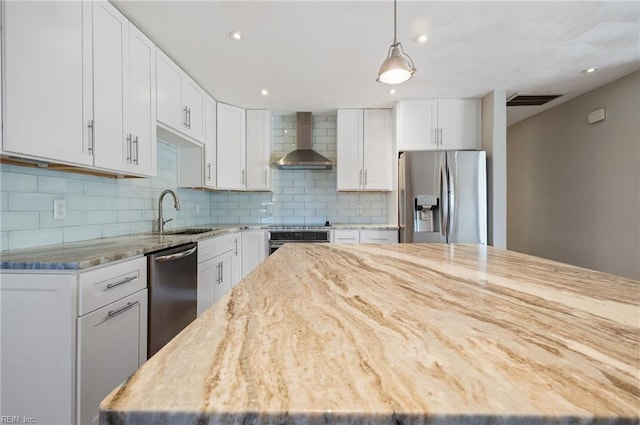 725 Lord Nelson Dr, Virginia Beach, VA 23464 - kitchen featuring stainless steel appliances, a sink, wall chimney range hood, light stone counters, and decorative backsplash