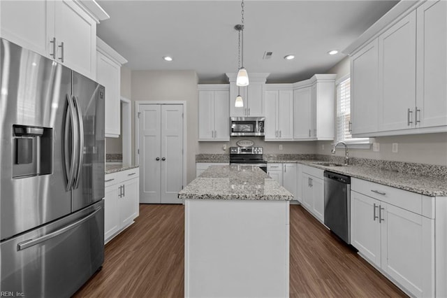 3745 Peterson St, Norfolk, VA 23513 - kitchen with stainless steel appliances, a sink, a center island, dark wood-type flooring, and white cabinets