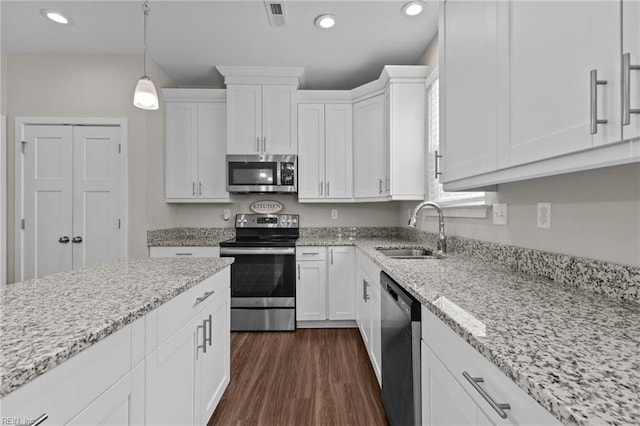 3745 Peterson St, Norfolk, VA 23513 - kitchen featuring appliances with stainless steel finishes, a sink, white cabinetry, recessed lighting, and dark wood-type flooring