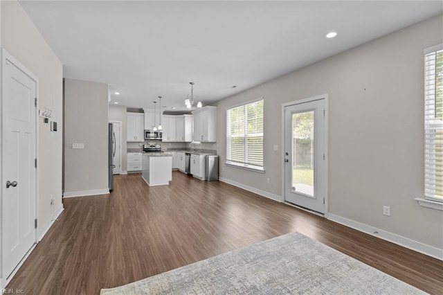 3745 Peterson St, Norfolk, VA 23513 - unfurnished living room with dark wood-style flooring, healthy amount of natural light, baseboards, a chandelier, and recessed lighting