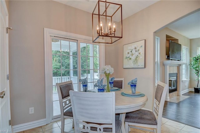 501 Beagle Gap Ct, Chesapeake, VA 23320 - dining room featuring light tile patterned flooring, a tile fireplace, and baseboards