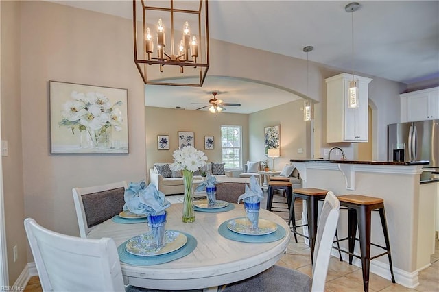 501 Beagle Gap Ct, Chesapeake, VA 23320 - dining space with arched walkways, a ceiling fan, light tile patterned flooring, and a chandelier