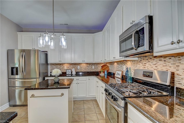 501 Beagle Gap Ct, Chesapeake, VA 23320 - kitchen featuring appliances with stainless steel finishes, a center island, light tile patterned floors, and white cabinets