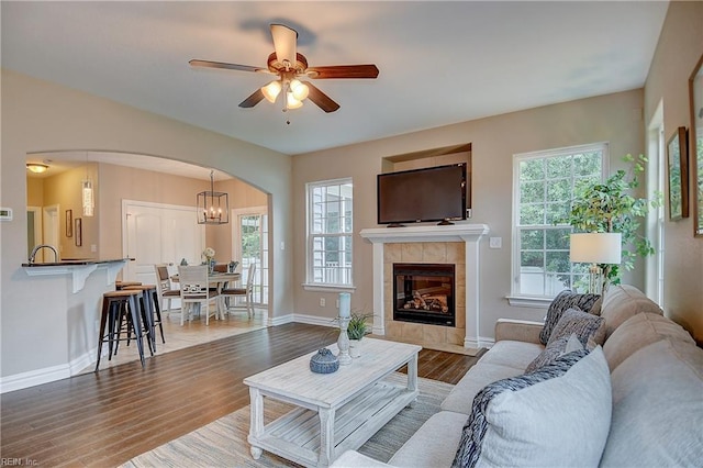 501 Beagle Gap Ct, Chesapeake, VA 23320 - living room featuring arched walkways, baseboards, wood finished floors, and ceiling fan