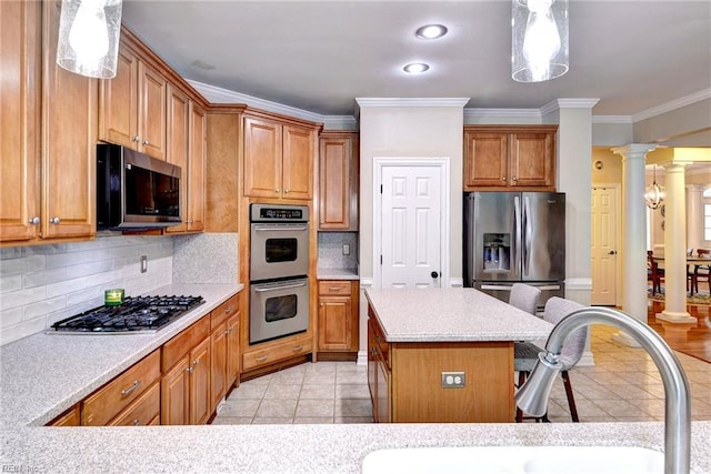 604 Schooner Blvd, Williamsburg, VA 23185 - kitchen featuring appliances with stainless steel finishes, a sink, ornate columns, a breakfast bar, and crown molding