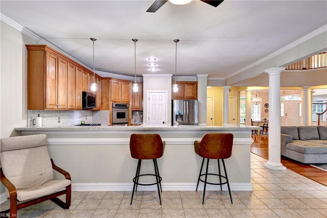 604 Schooner Blvd, Williamsburg, VA 23185 - kitchen with stainless steel appliances, ornate columns, a peninsula, light countertops, and ornamental molding