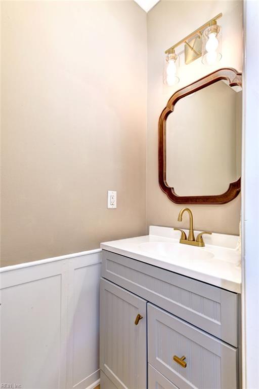 604 Schooner Blvd, Williamsburg, VA 23185 - bathroom featuring vanity, wainscoting, and a decorative wall