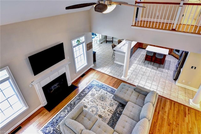 604 Schooner Blvd, Williamsburg, VA 23185 - living area with a ceiling fan, wood finished floors, high vaulted ceiling, a fireplace with raised hearth, and baseboards