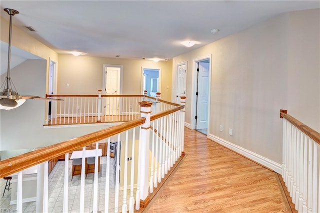 604 Schooner Blvd, Williamsburg, VA 23185 - corridor featuring an upstairs landing, light wood finished floors, and baseboards