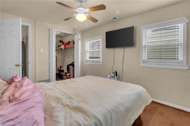 2020 County St, Portsmouth, VA 23704 - bedroom featuring wood finished floors, baseboards, a ceiling fan, a walk in closet, and a closet