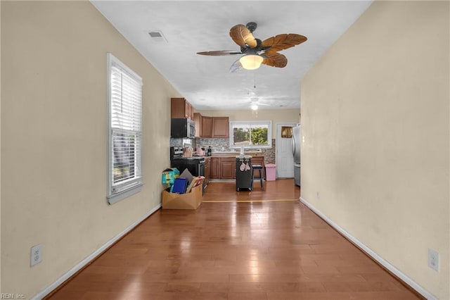 2020 County St, Portsmouth, VA 23704 - living area featuring ceiling fan, wood finished floors, and baseboards