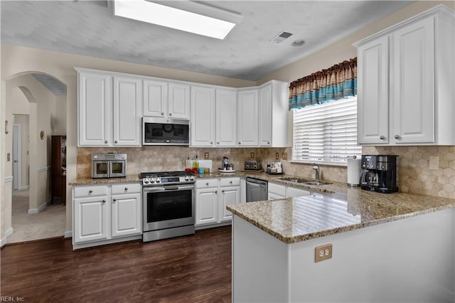 2612 Einstein Dr, Virginia Beach, VA 23456 - kitchen with stainless steel appliances, a sink, white cabinets, and dark wood finished floors