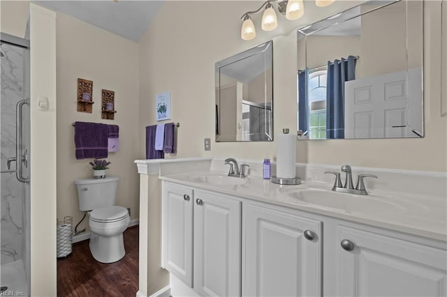 2612 Einstein Dr, Virginia Beach, VA 23456 - full bath with a marble finish shower, double vanity, toilet, and wood finished floors