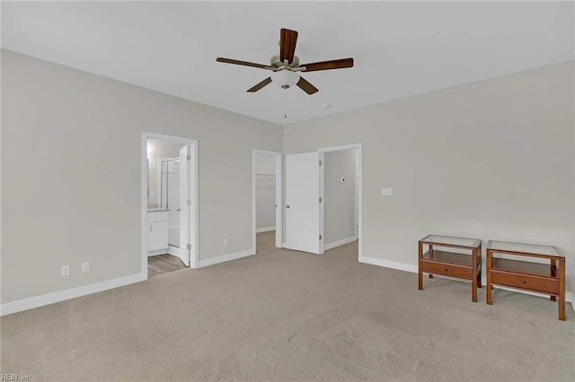 101 Daybeacon St, Yorktown, VA 23692 - unfurnished bedroom with carpet, baseboards, a walk in closet, ensuite bath, and a ceiling fan