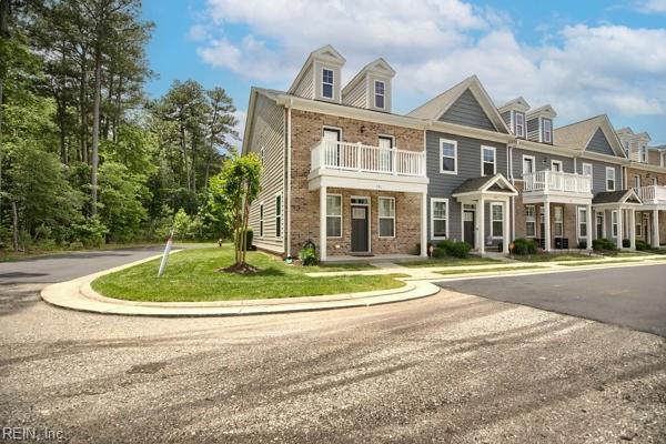 101 Daybeacon St, Yorktown, VA 23692 - view of property with brick siding, a balcony, and a front lawn