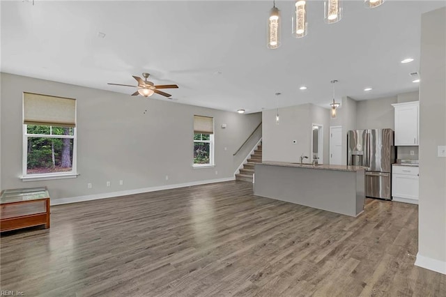 101 Daybeacon St, Yorktown, VA 23692 - unfurnished living room featuring baseboards, wood finished floors, ceiling fan, recessed lighting, and stairway